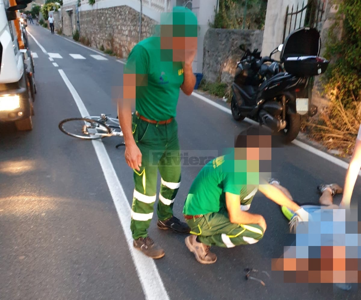Ciclista si schianta contro la portiera di un mezzo dell’igiene urbana