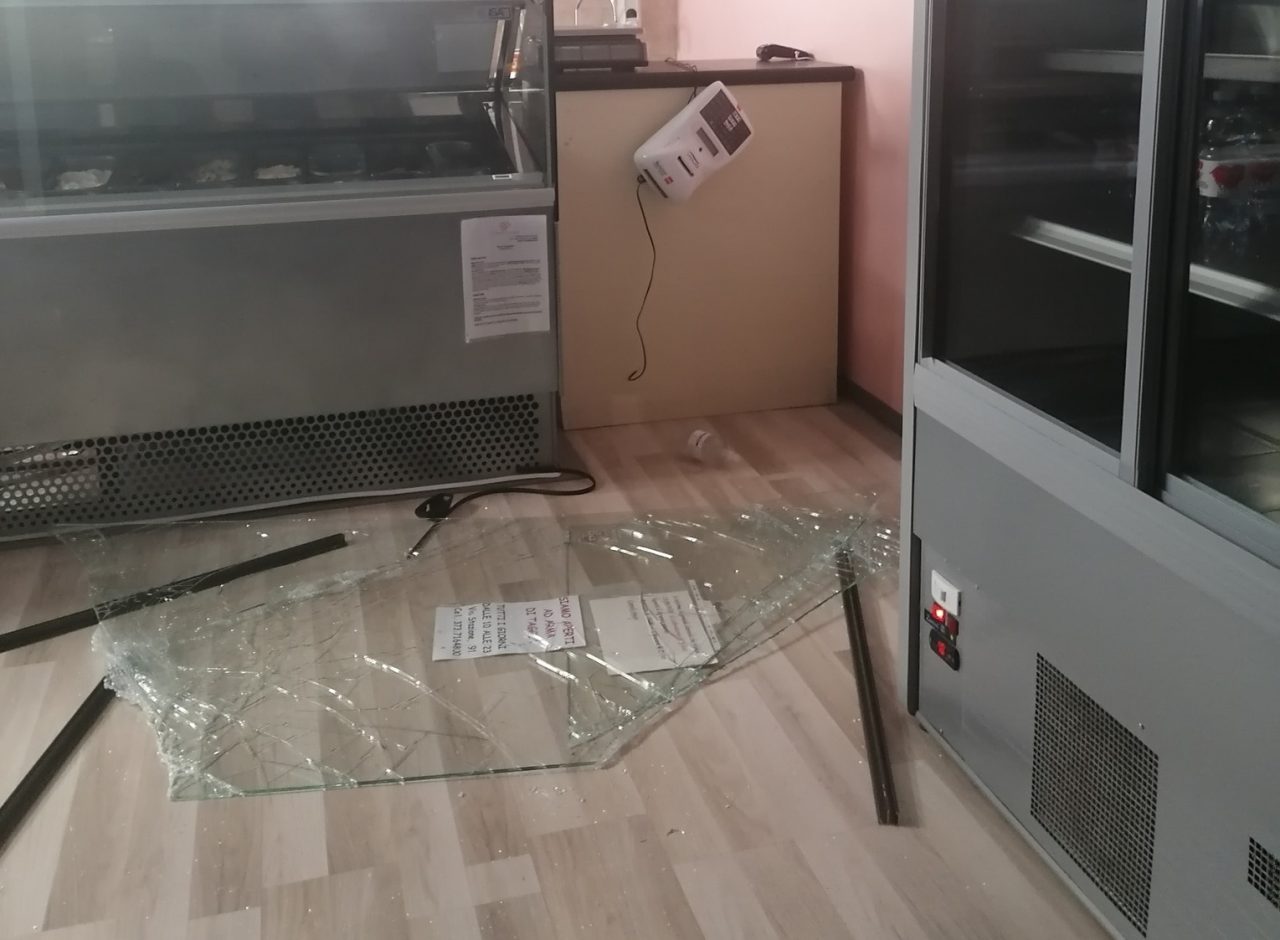 Prendono tombino di ghisa e spaccano vetrata di una gelateria